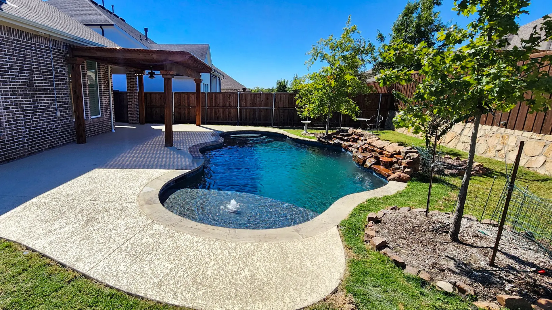 Freeform Pool with Weeping Wall and Pergola